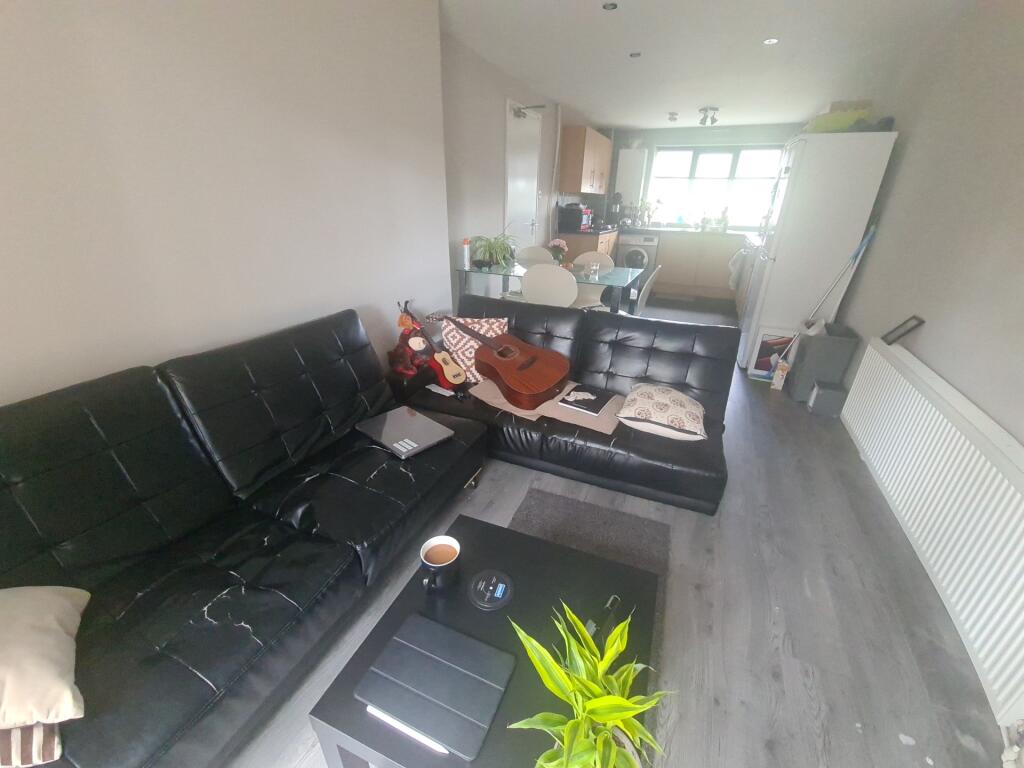Contemporary living room featuring a sleek blac...