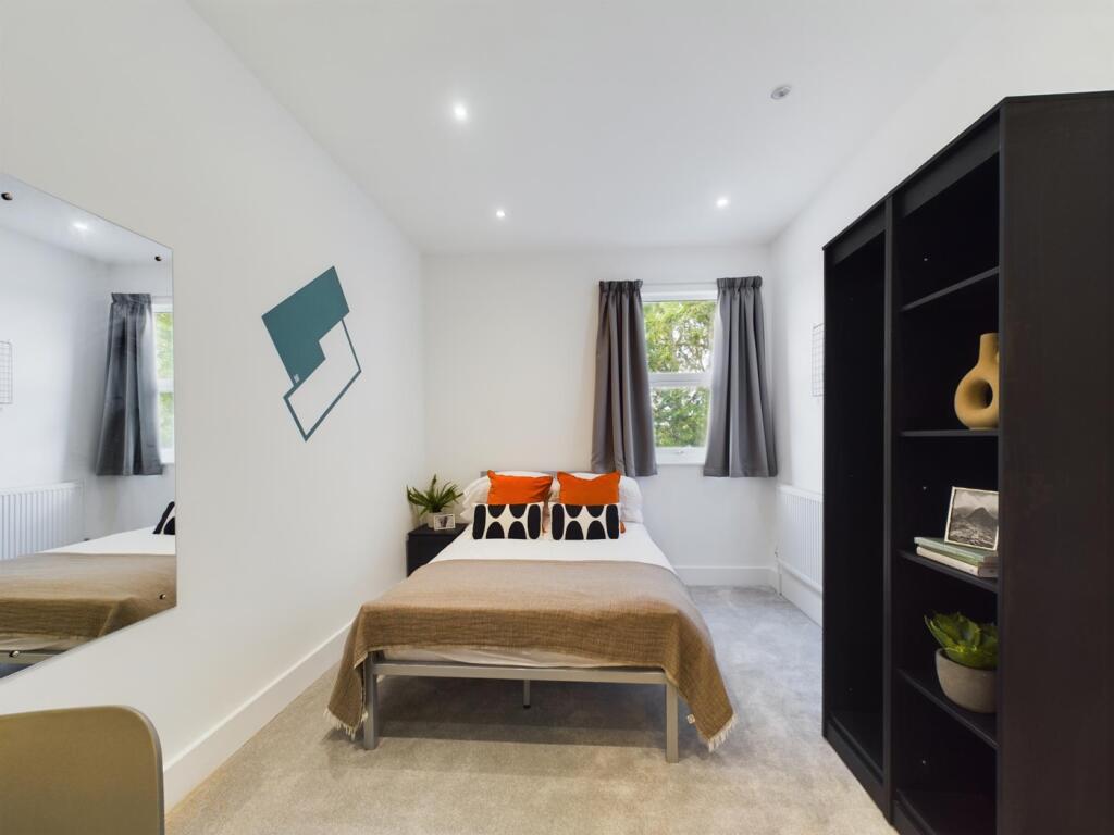A bright and inviting double bedroom featuring ...