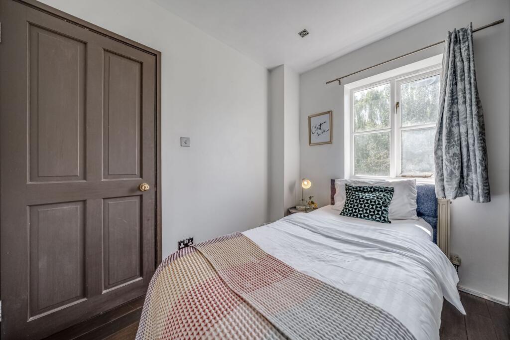 A bright and cozy single bedroom featuring a ne...