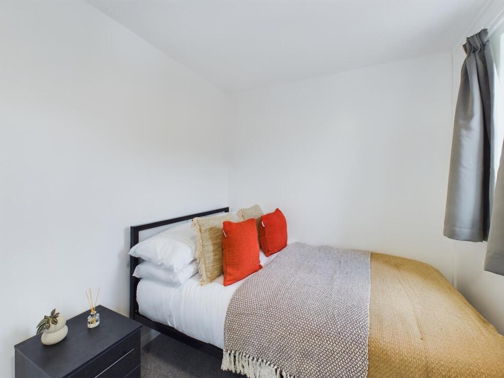A bright and inviting double bedroom featuring ...