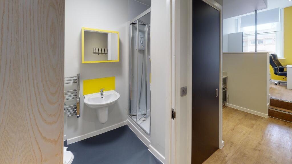 Bright and modern bathroom suite featuring a sl...