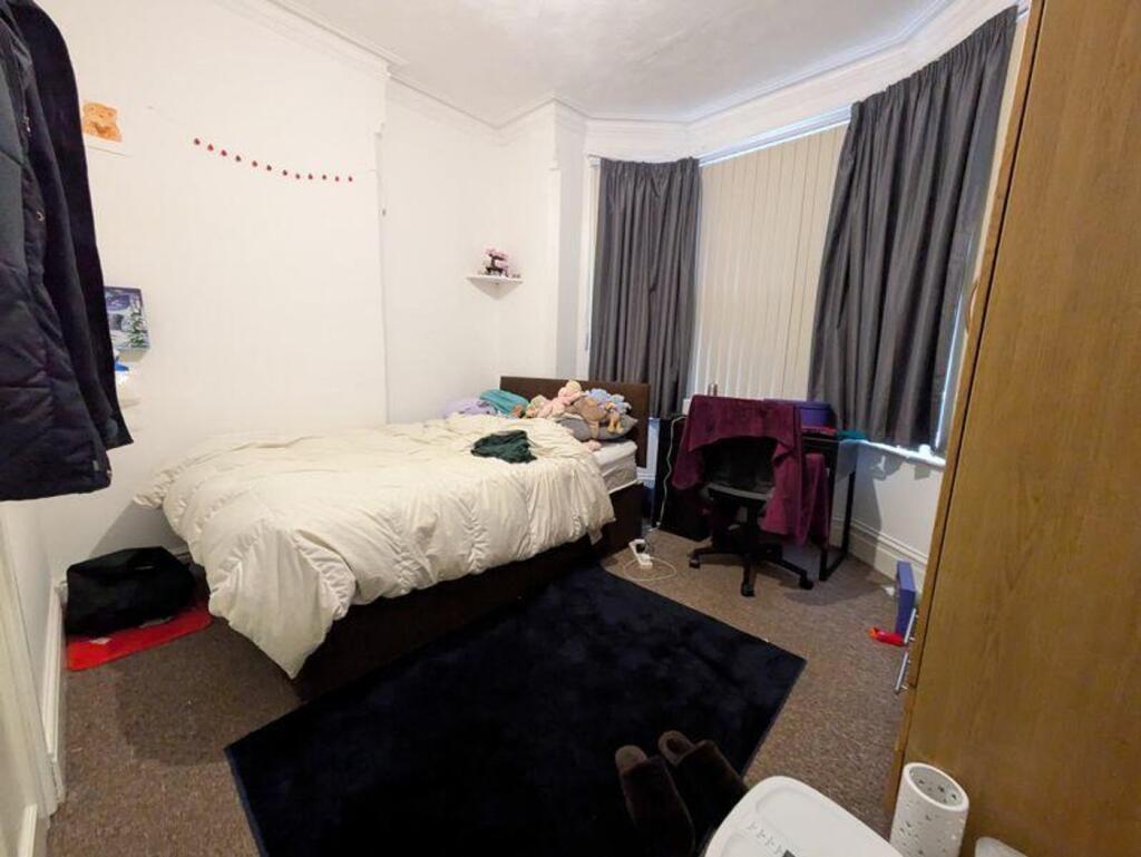 A cozy double bedroom featuring a comfortable b...