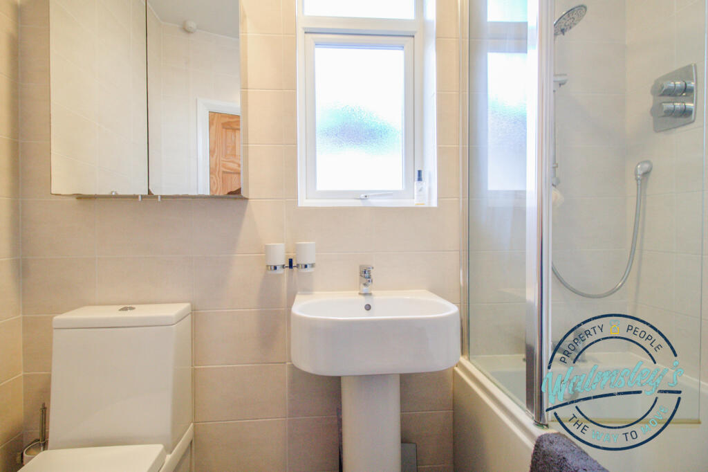 Bathroom with mains shower over bath