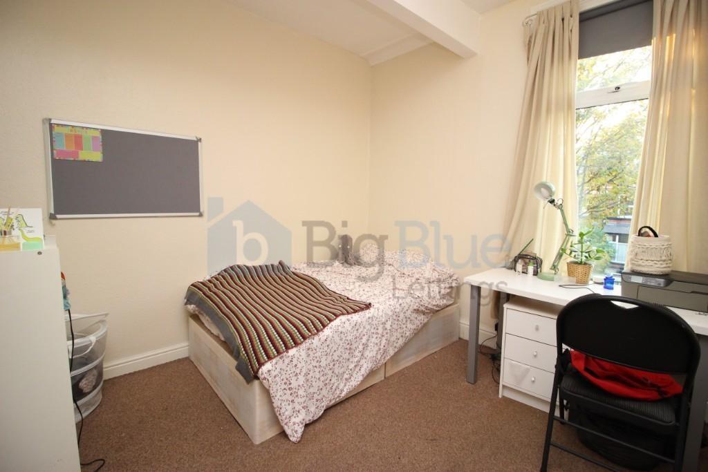 Cozy single bedroom featuring a comfortable bed...