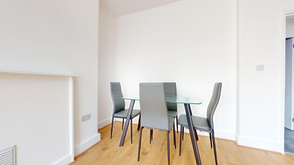 A modern living room featuring a sleek glass di...