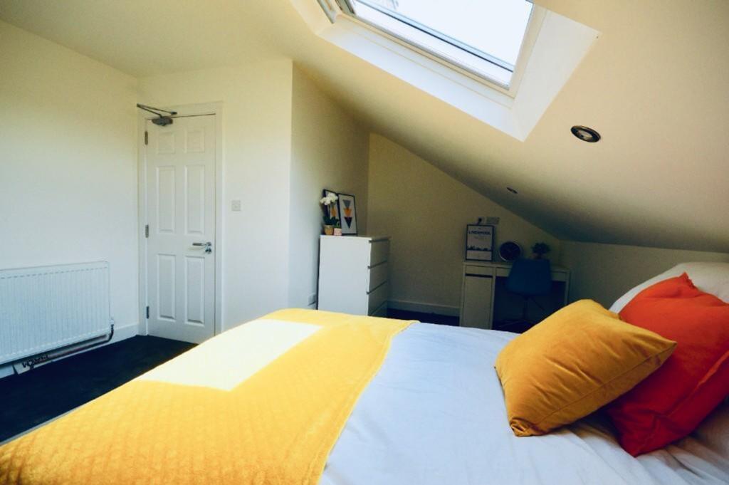 A bright and inviting double bedroom featuring ...