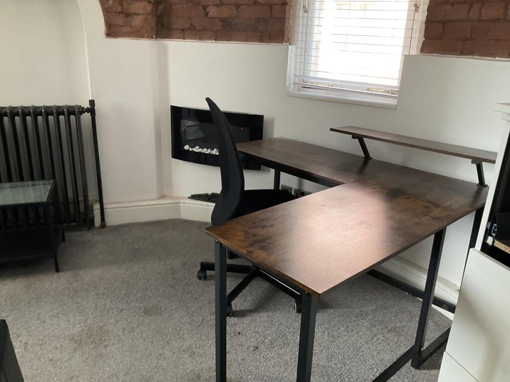 A bright and tidy communal workspace featuring ...