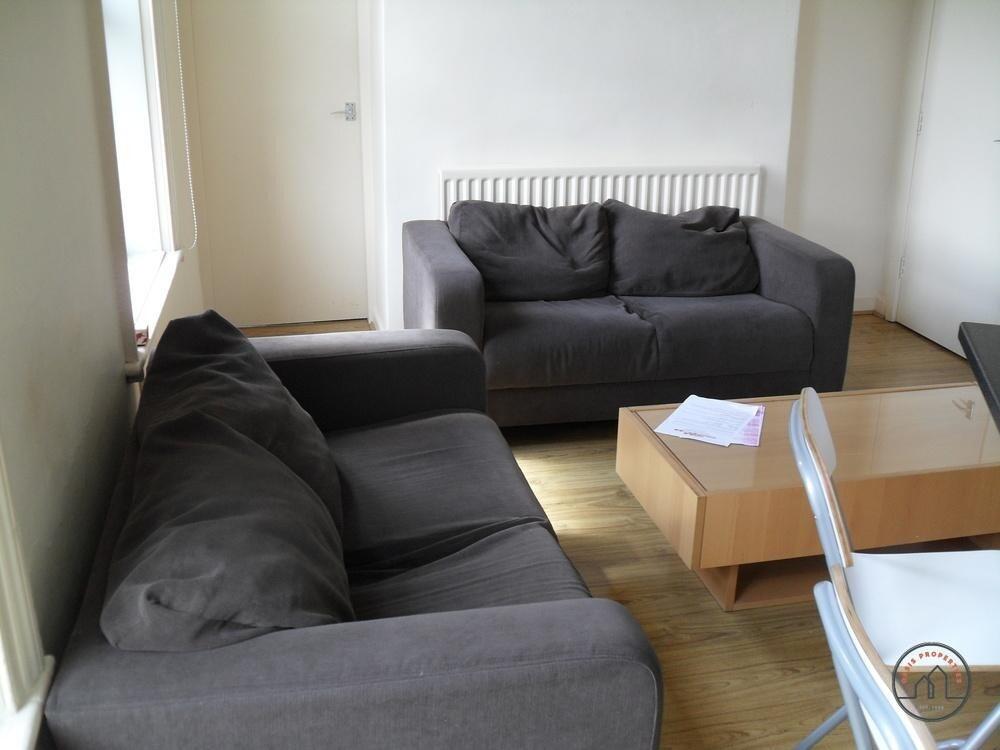 A bright and welcoming living room featuring tw...