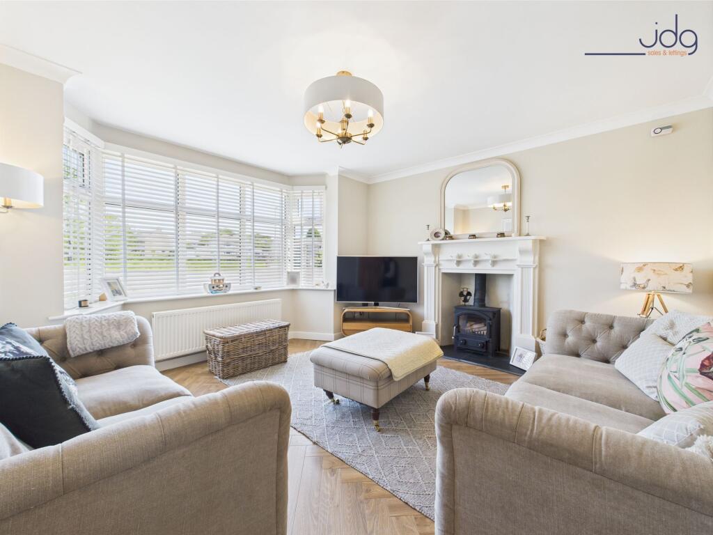 Cosy bay-fronted lounge with multi-fuel stove