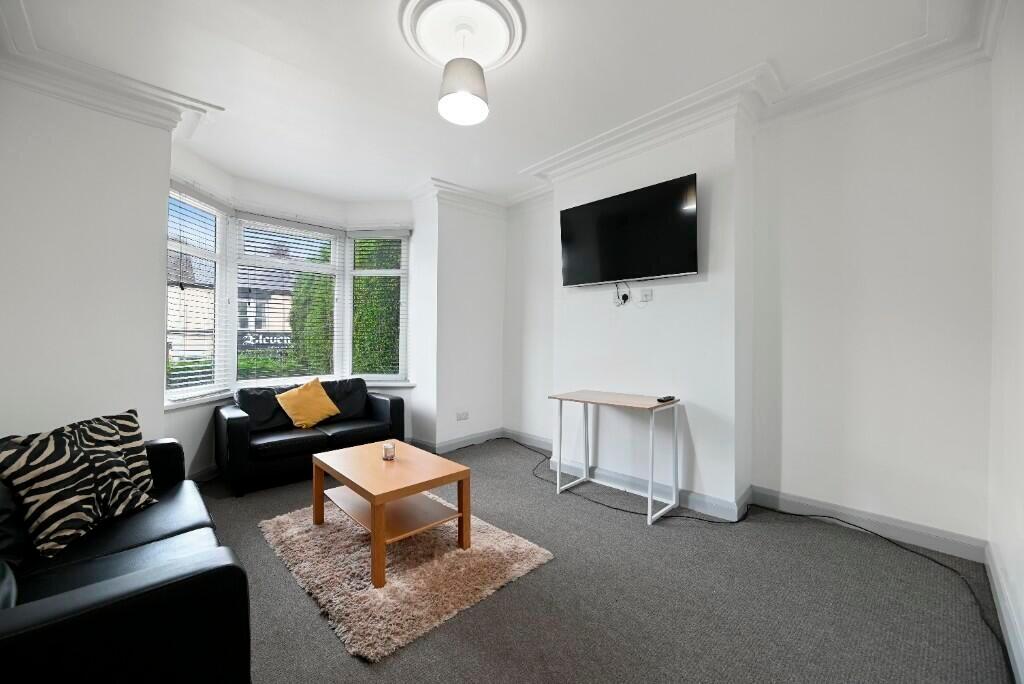 A bright and welcoming living room featuring la...