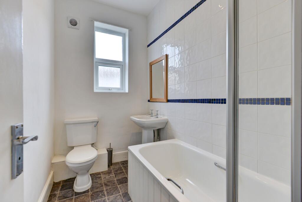 Bright and clean bathroom featuring a full-size...