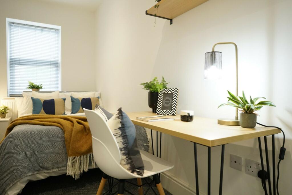 A bright and inviting double bedroom featuring ...