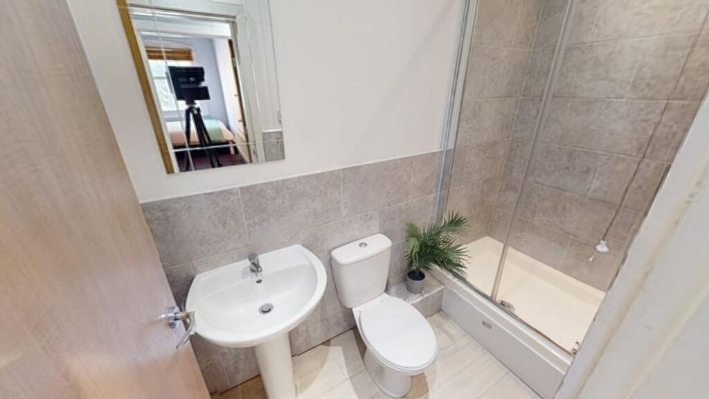 A clean and modern bathroom featuring a white s...
