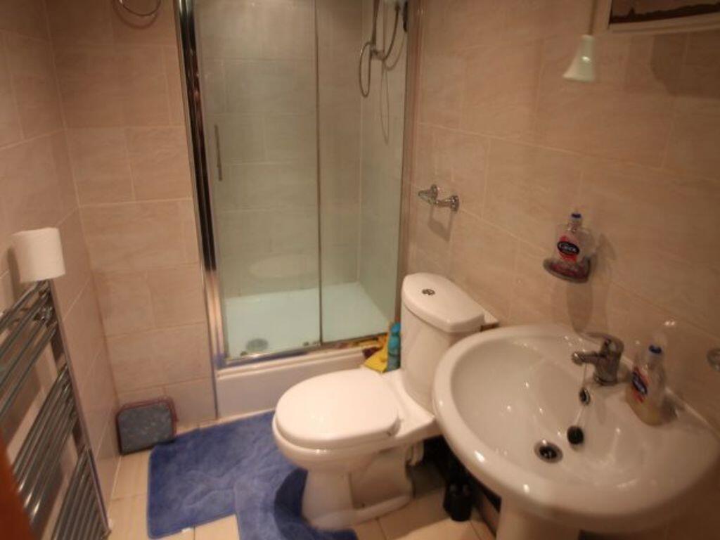 A well-maintained bathroom with a toilet, sink,...