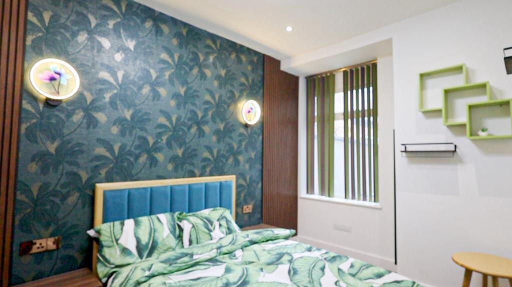 A stylish double bedroom featuring vibrant deco...