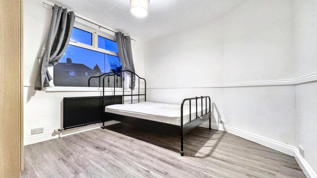 A bright and inviting double bedroom featuring ...