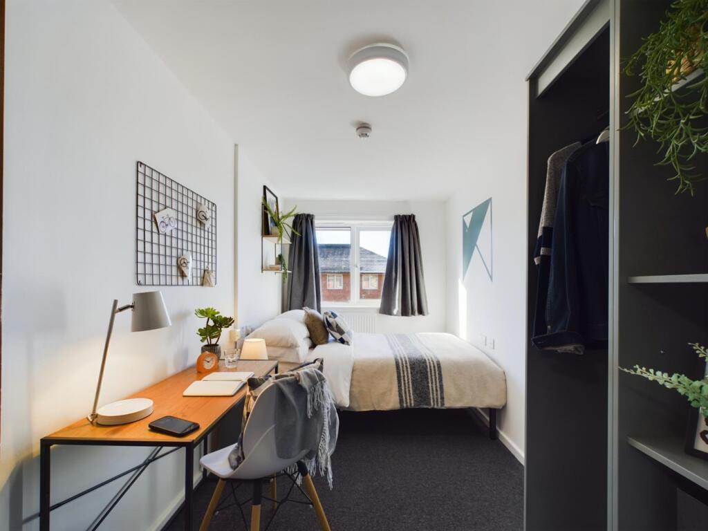 A bright and inviting double bedroom featuring ...