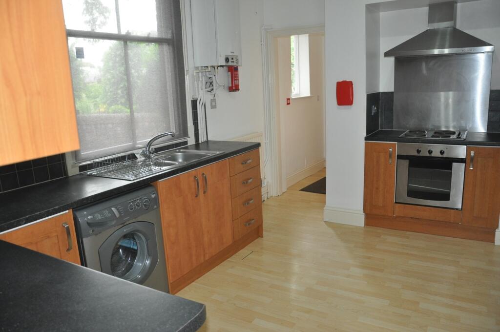 A modern kitchenette with ample space and natur...