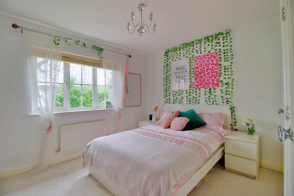 Bedroom with fitted wardrobes and garden view