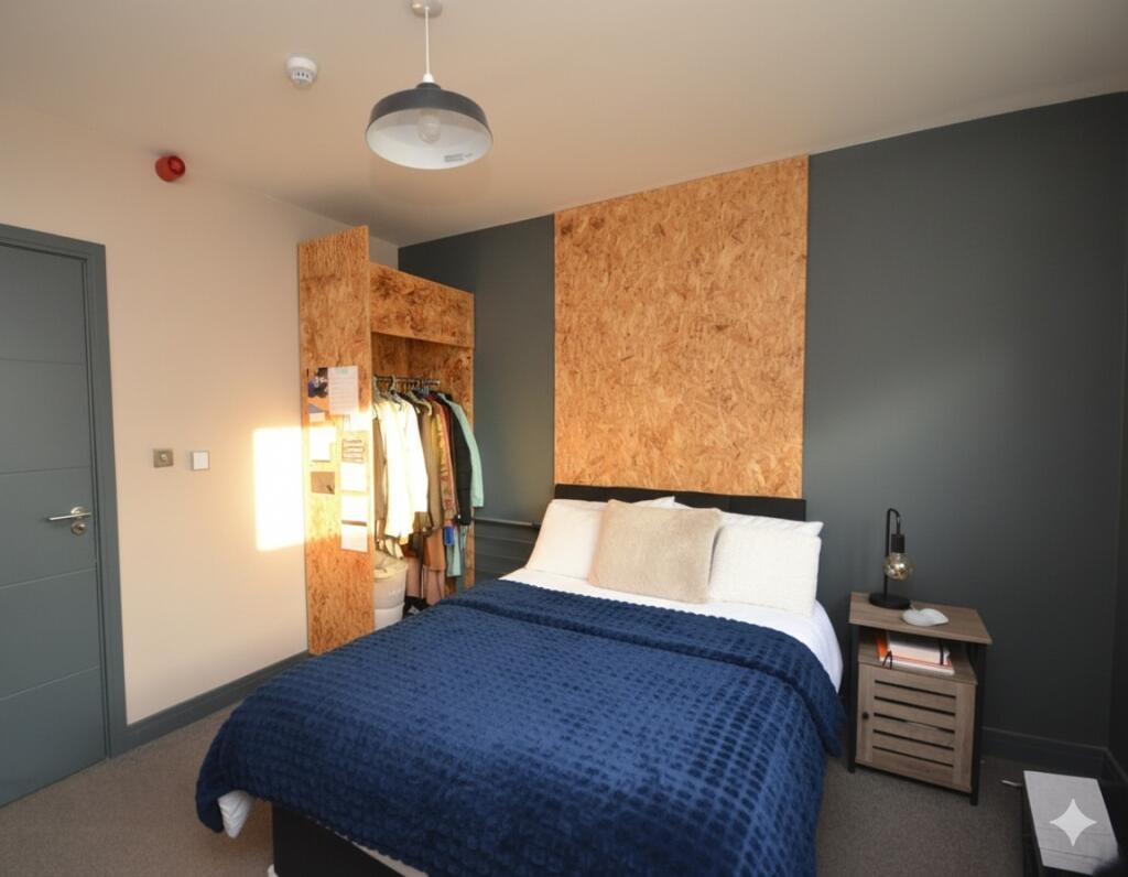 A modern bedroom featuring a neatly made bed wi...