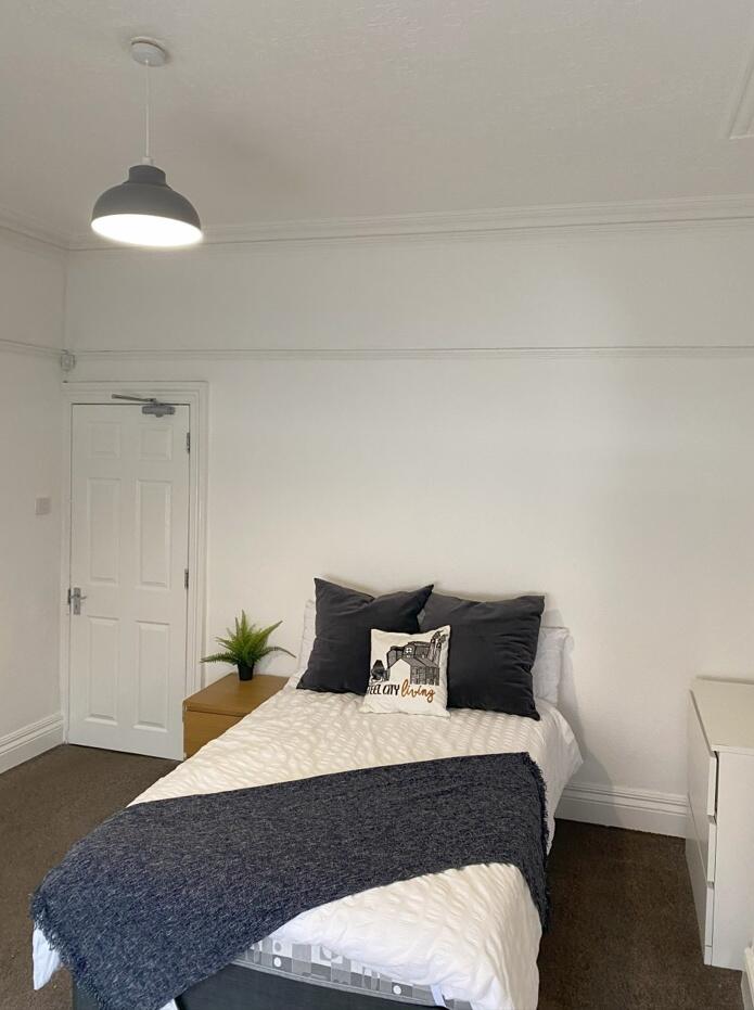 This inviting double bedroom features a cozy la...