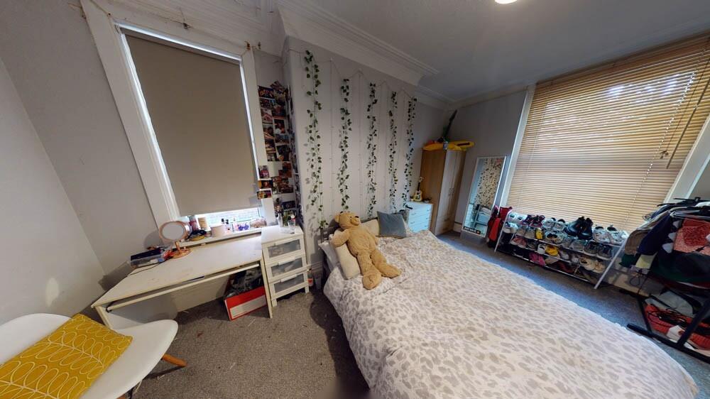 A cozy double bedroom featuring a comfortable d...