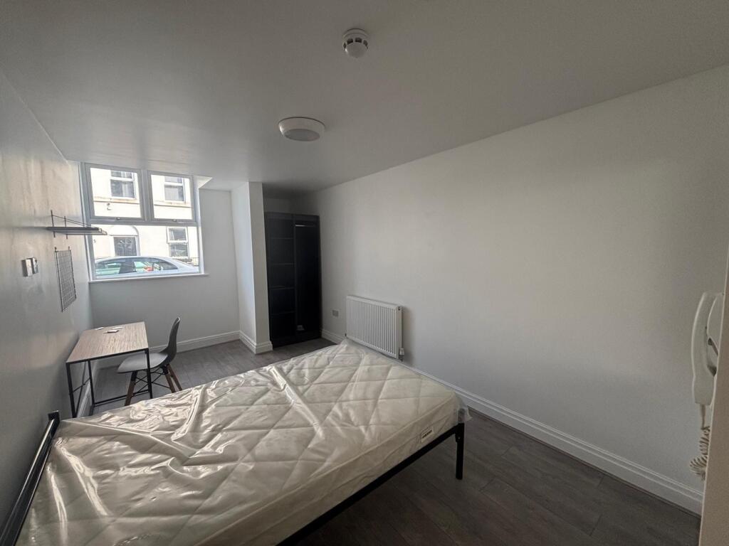 Spacious double bedroom featuring large windows...