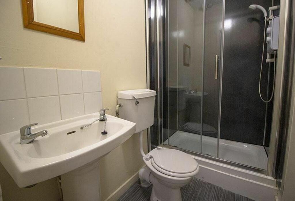 This well-maintained bathroom features a modern...