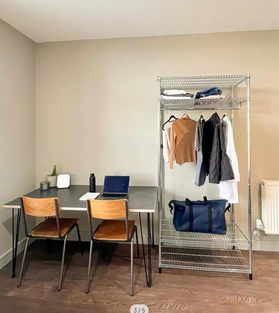 A tidy and well-lit communal workspace featurin...