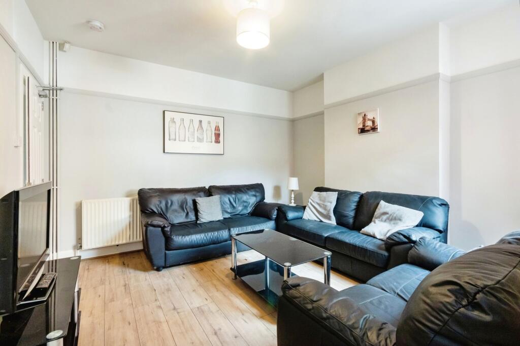 A spacious and contemporary living room featuri...