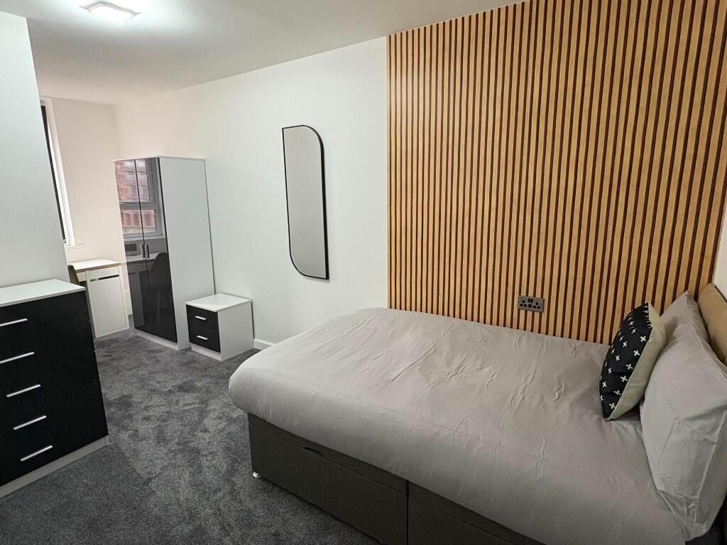 A modern double bedroom featuring a comfortable...