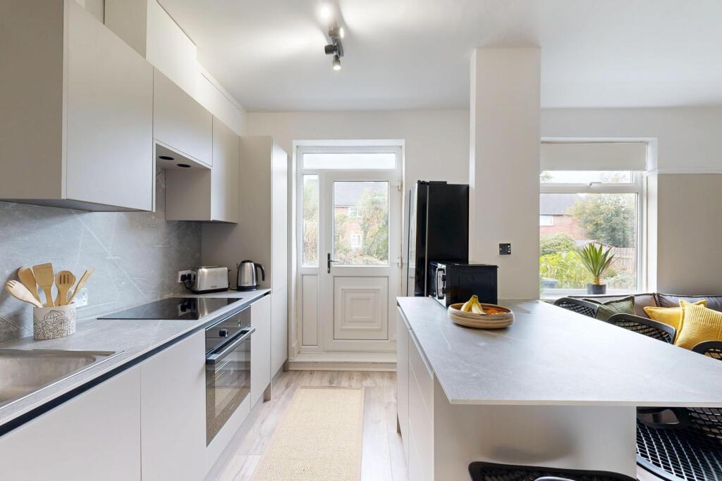 Bright and modern kitchen with ample natural li...
