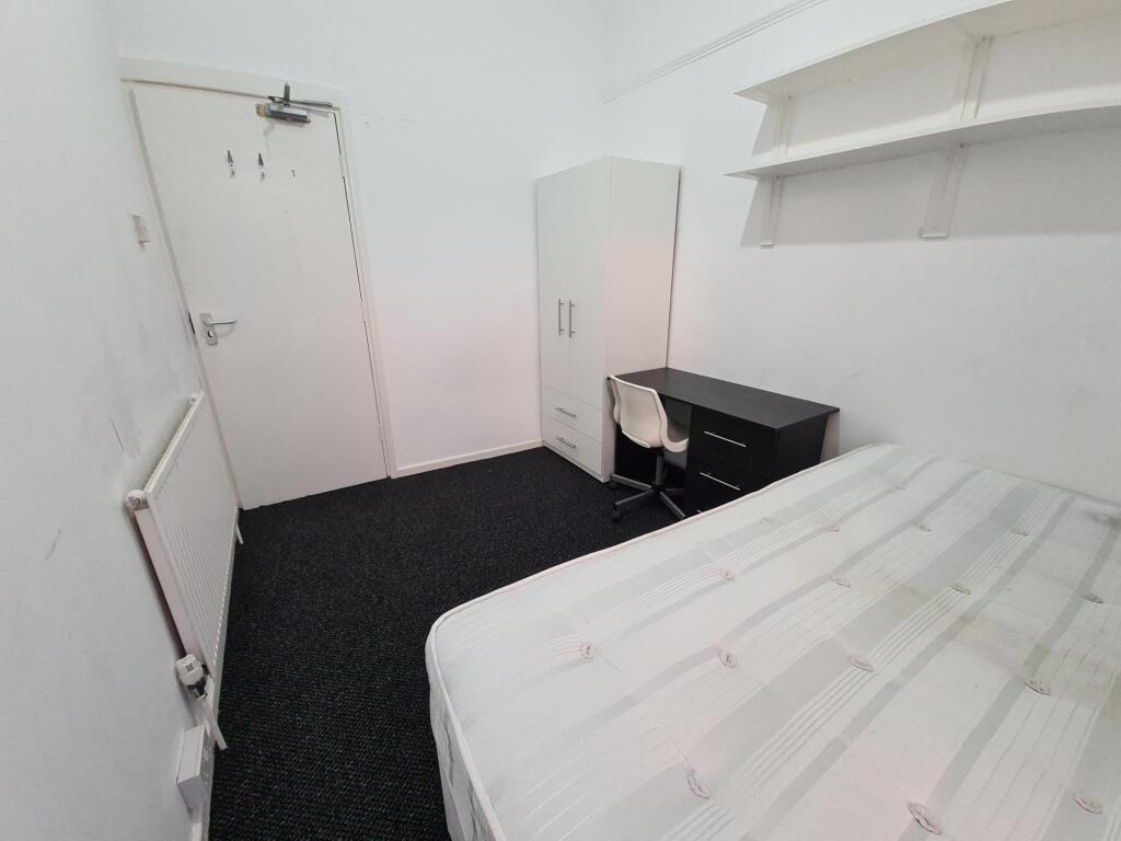 A tidy and well-maintained bedroom with a comfo...