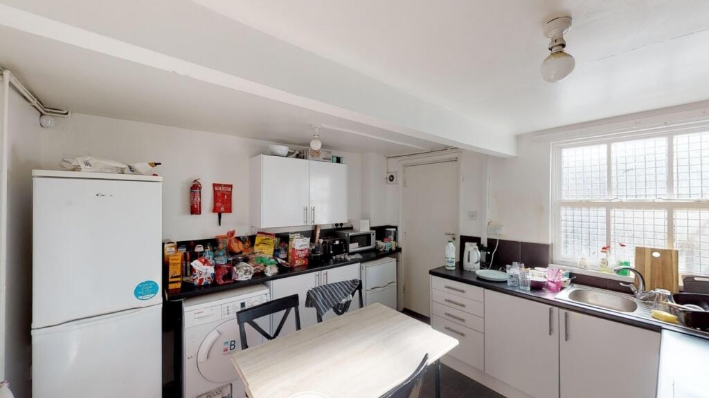 Bright kitchen featuring ample counter space, m...