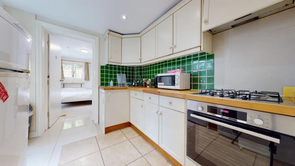 Bright and tidy kitchen featuring modern applia...