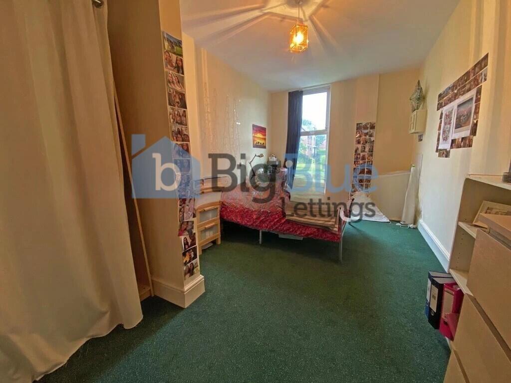 A neatly arranged bedroom featuring a single be...