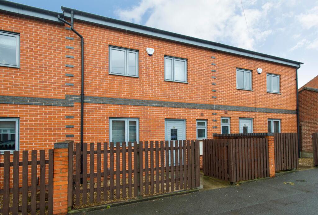 Charming exterior view of a stylish brick prope...