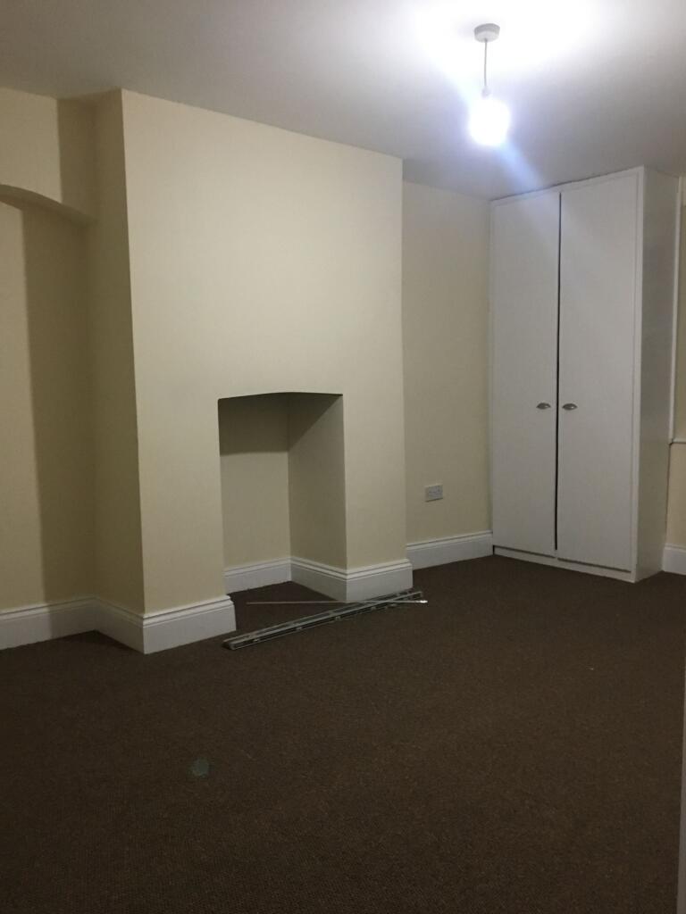 Neutral, freshly painted bedroom with fitted wa...