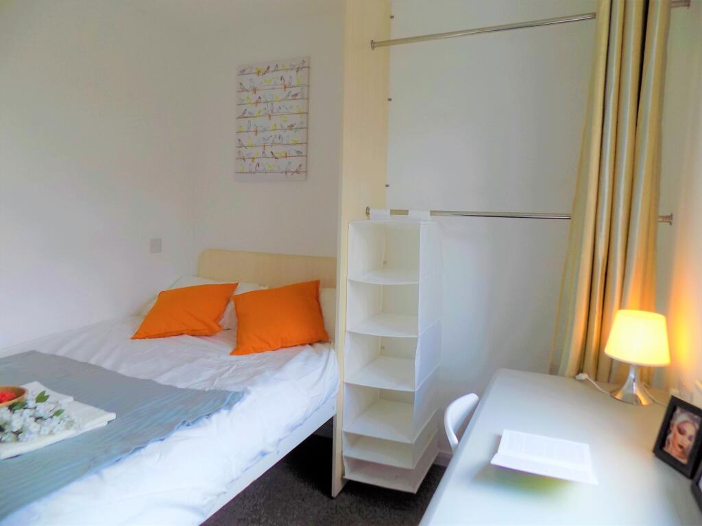 A cozy double bedroom featuring a neatly made b...