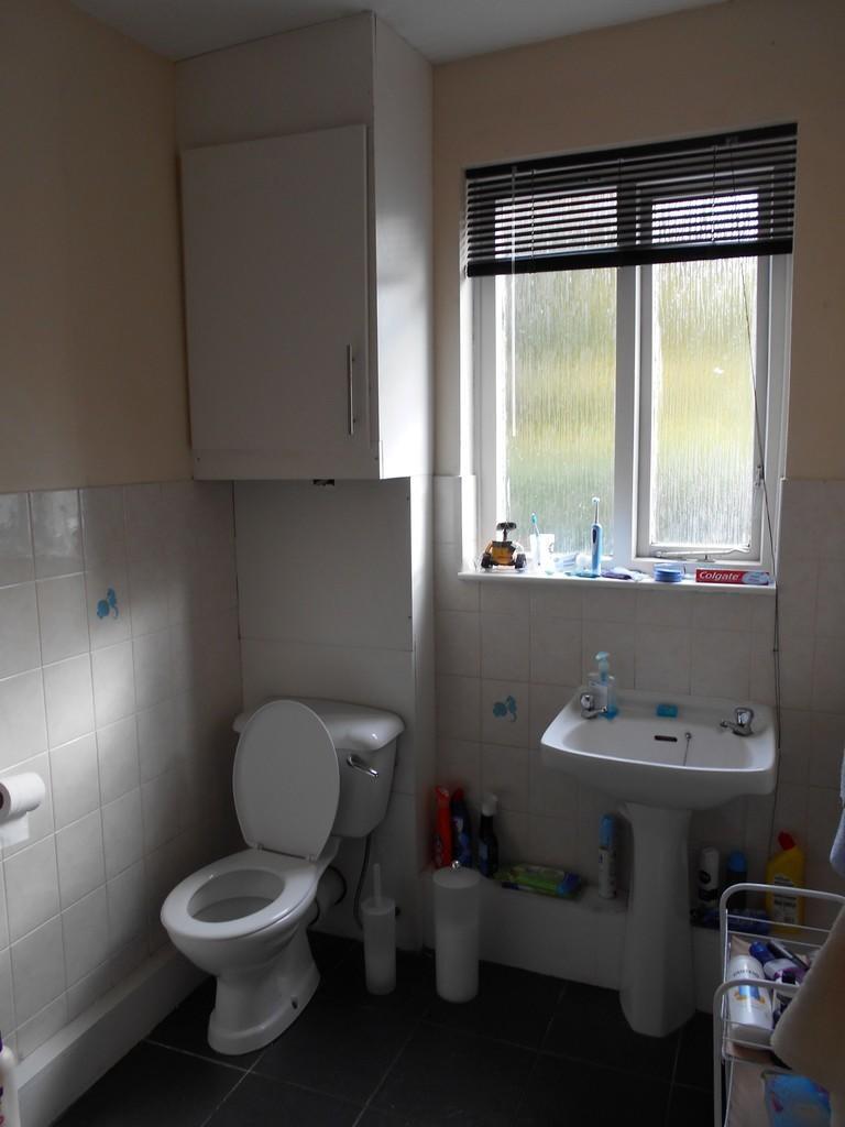 A neat and functional bathroom featuring a toil...