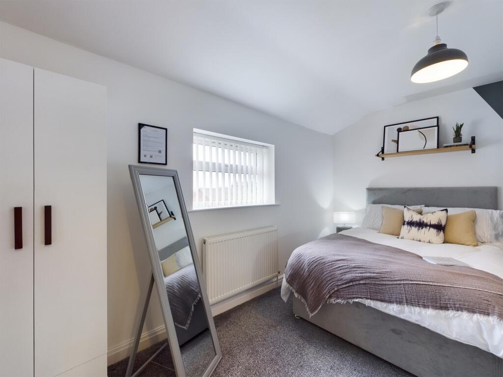 A bright and inviting double bedroom featuring ...