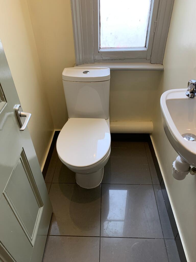 A modern and clean single toilet with a sleek d...