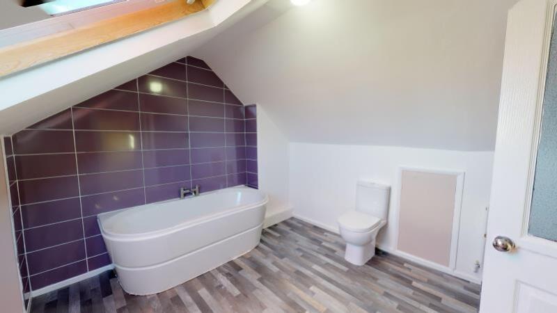 A modern bathroom suite featuring a sleek batht...