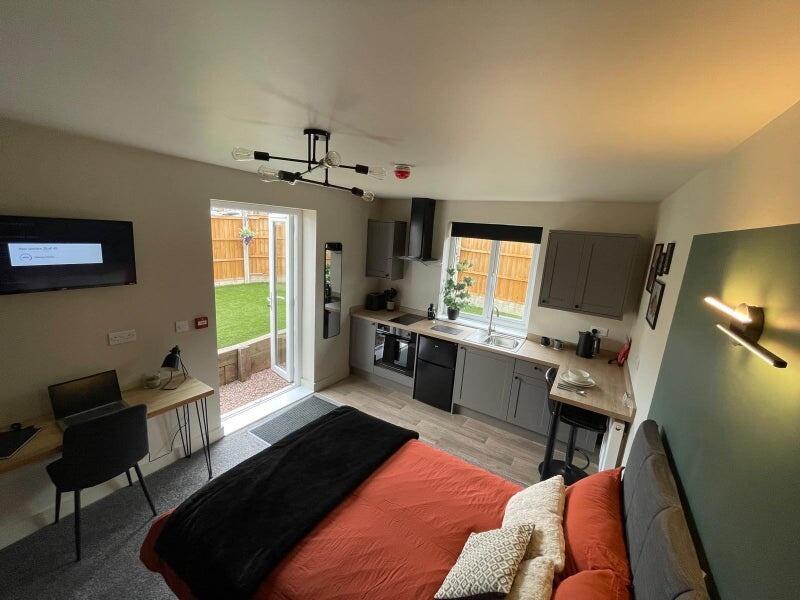 Bright and modern master bedroom featuring a co...
