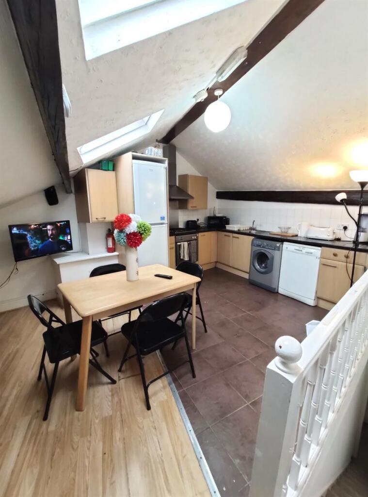 Bright and modern kitchen with sloped ceilings ...