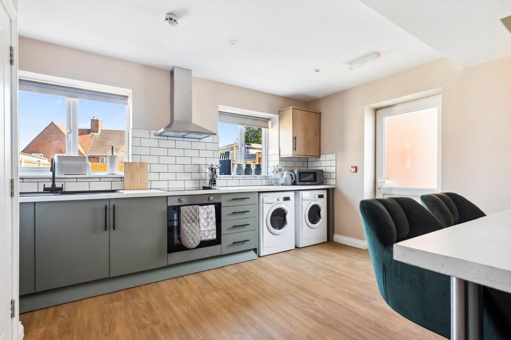 Bright and modern kitchen featuring ample count...