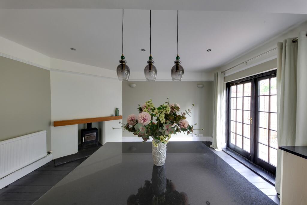view to dining area and log burner