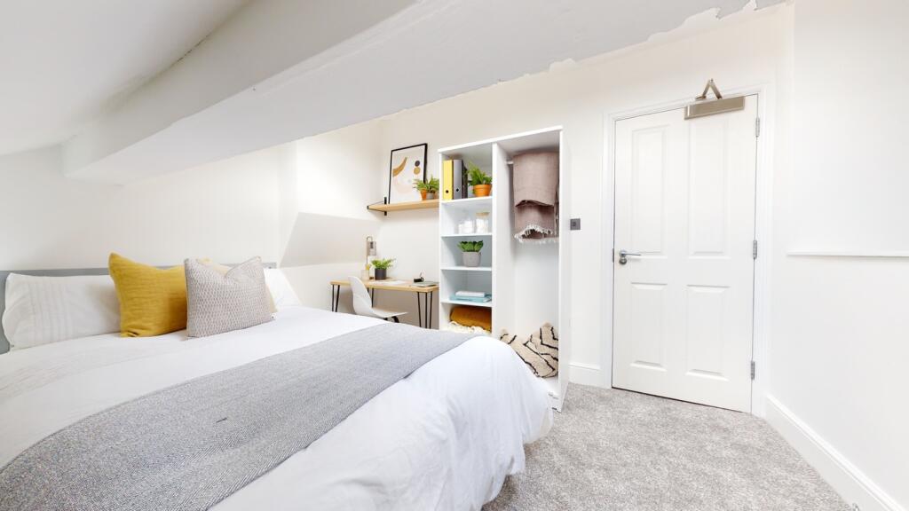 A bright and spacious double bedroom featuring ...