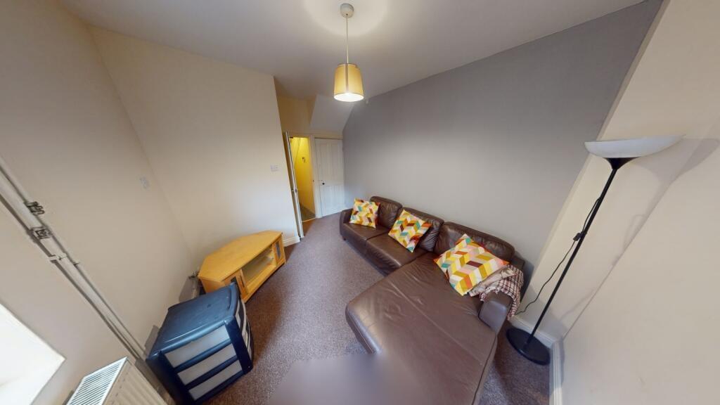 Cozy living room featuring a comfortable sofa w...