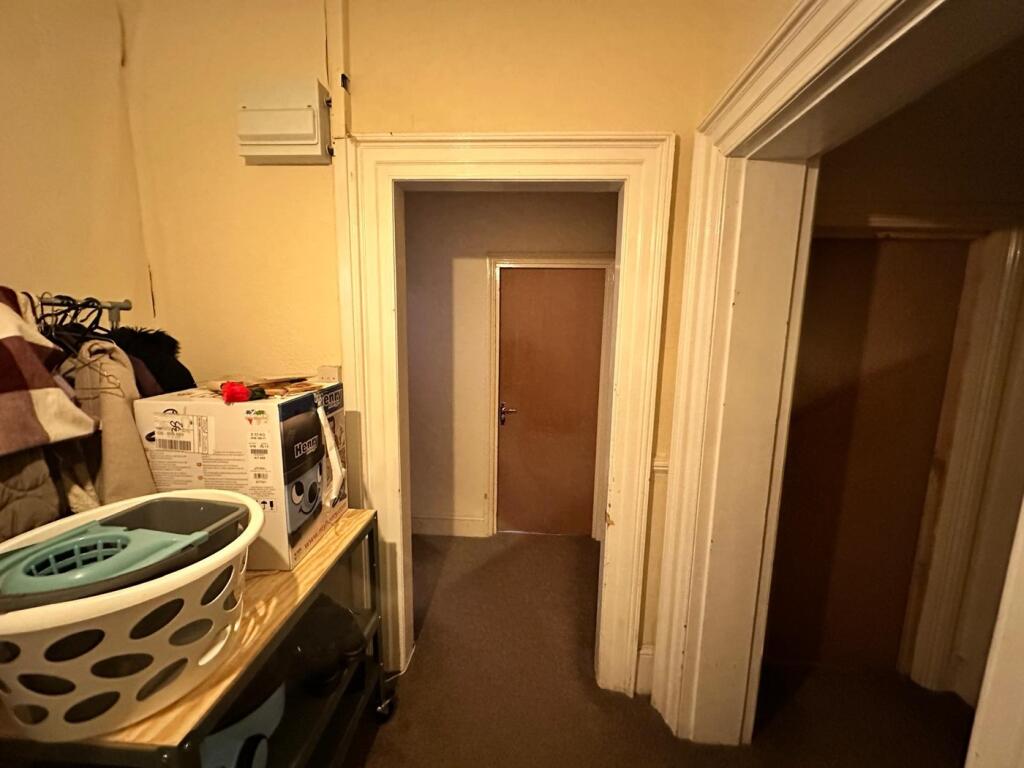 A spacious hallway featuring well-maintained wa...